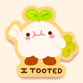A cute cartoon sticker or graphic of a white rounded character with green leaf sprout, pink cheeks, brown feet, and the text 'I TOOTED' with 'mochi Blushi' underneath, shown on a pale cream background.
